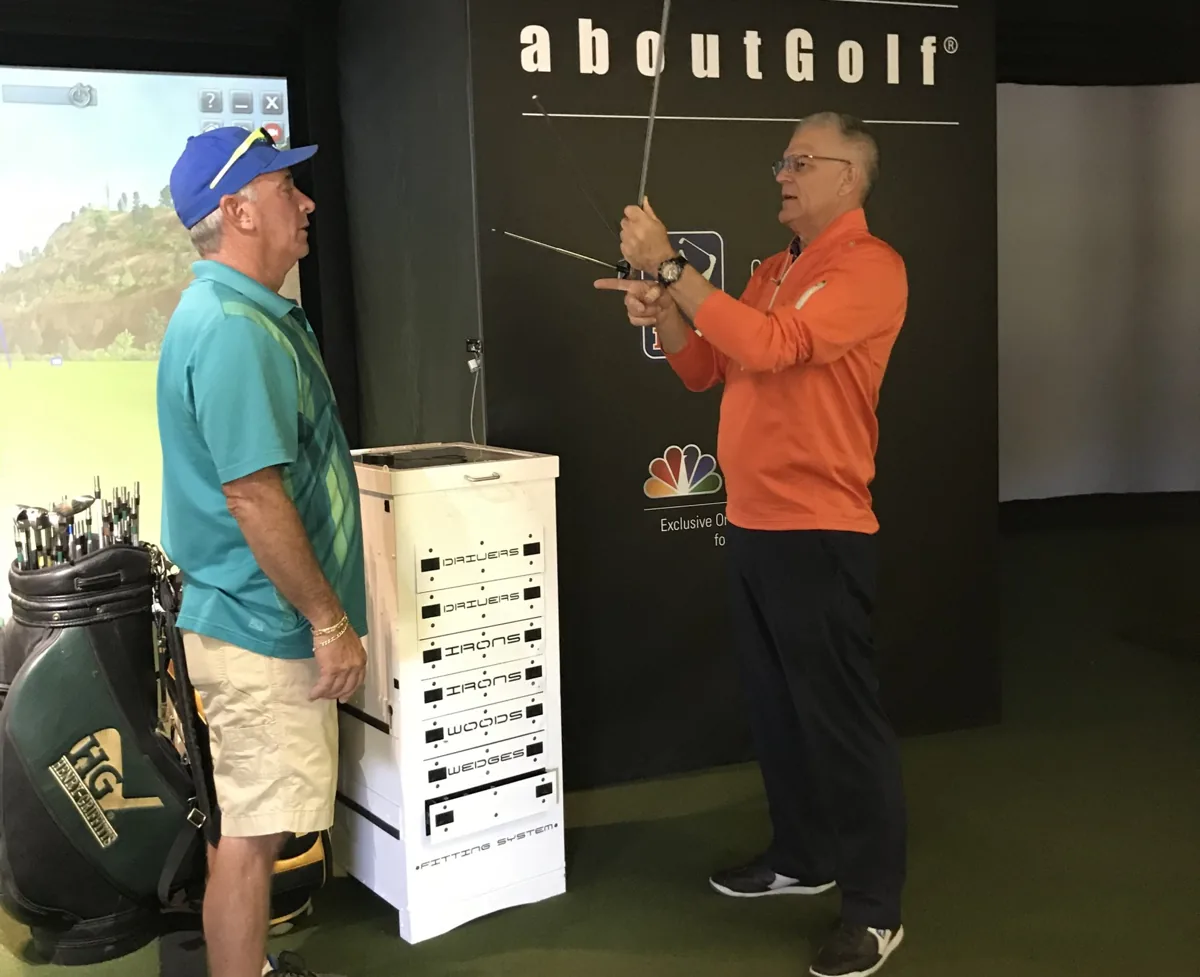 Gaylord Rhodes checking a shaft with a client in the fitting studio