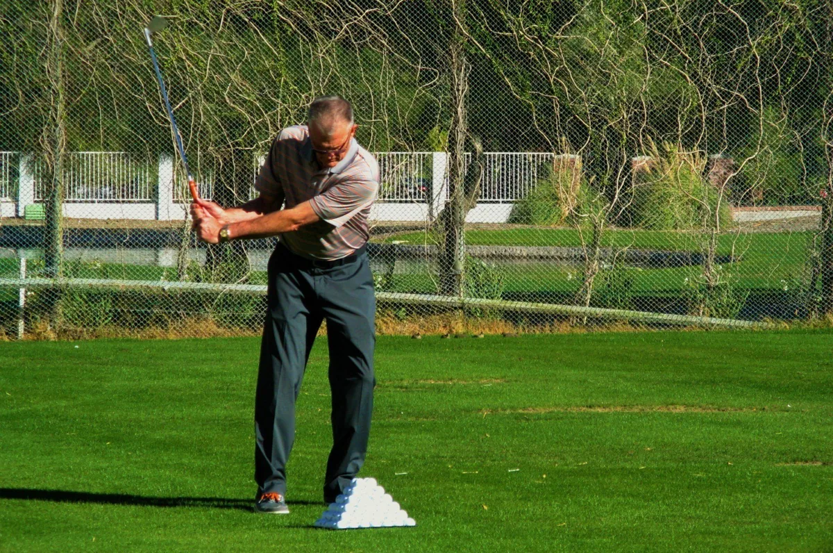 Gaylord Rhodes mid-backswing on a practice range