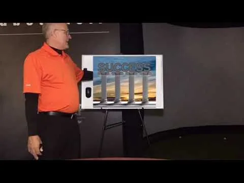 The coach presenting beside an easel